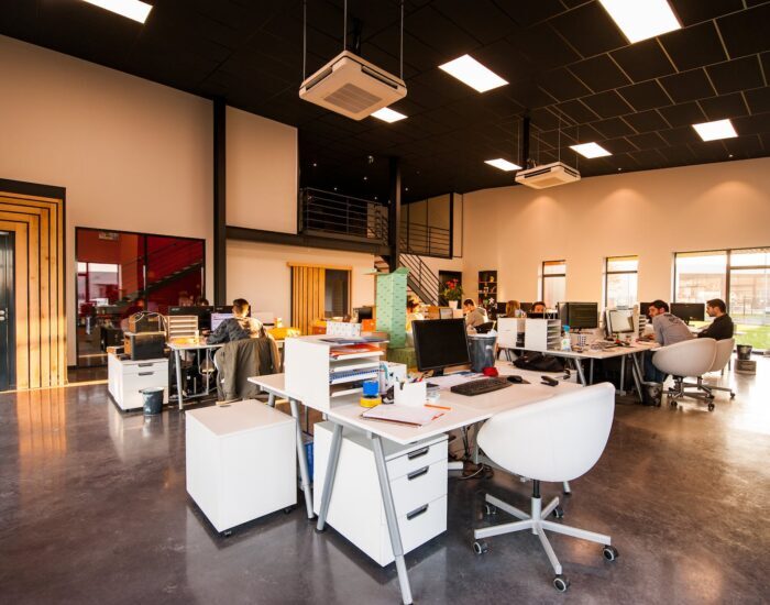 people sitting on chairs beside their desks in an office