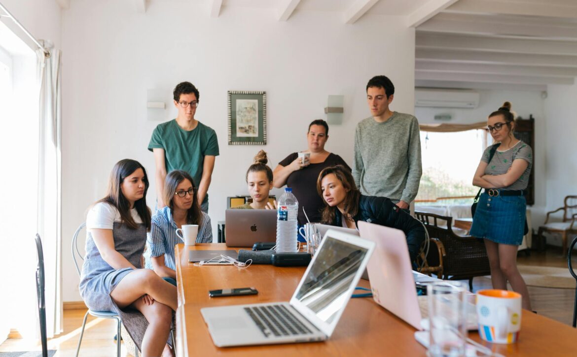 group of people watching on laptop