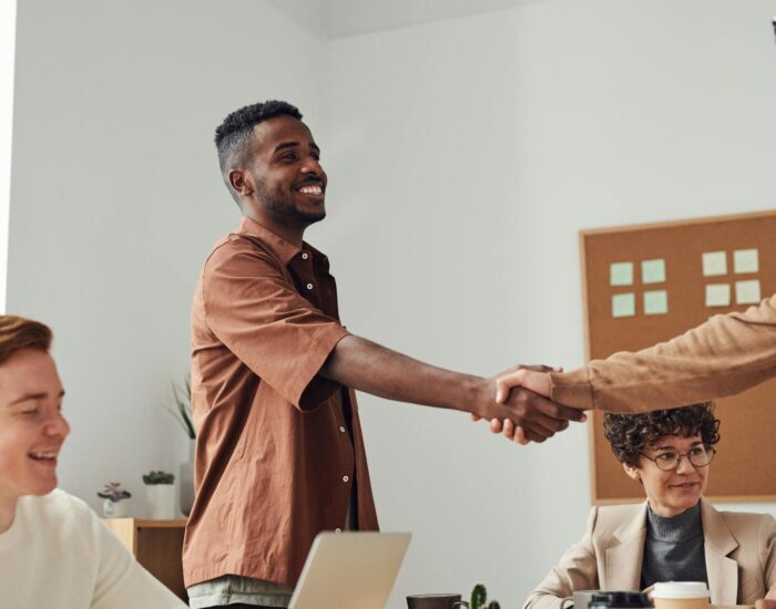 man in brown sport shirt shaking hands of man